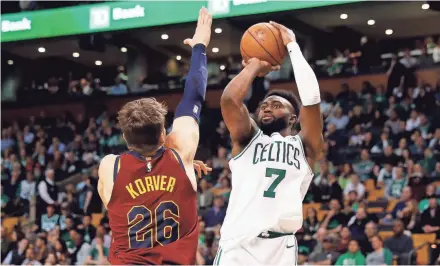  ?? WINSLOW TOWNSON / USA TODAY SPORTS ?? Celtics guard Jaylen Brown shoots over Cavaliers guard Kyle Korver during Game 1 on Sunday. Brown scored 23 points for Boston, which went on a 17-0 run in the first quarter to take control. The Cavaliers never got within single digits after that.