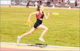  ??  ?? Amy Jarvis in full flight in the grade 11 girls 200m.