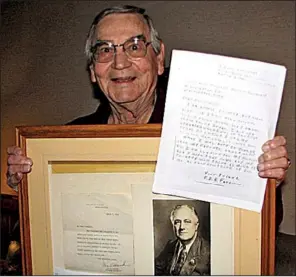  ?? Courtesy of Sherri DeCoursey ?? Forest Delano Roosevelt Ferguson holds a framed letter and photo he received from President Franklin Delano Roosevelt and a copy of the letter he sent to the president at age 8 in 1941.
