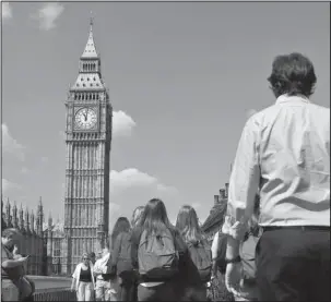  ?? The Associated Press ?? MOMENT OF SILENCE: In this May 25 photo, people observe a minute of silence in Westminste­r in London, after the suicide attack at an Ariana Grande concert that left more than 20 people dead and many more injuredat the Manchester Arena. The jihadis'...