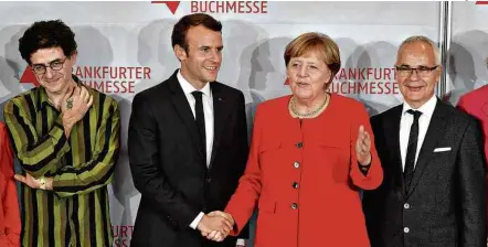  ?? John MacDougall/AFP ?? Mouawad, os líderes da França e da Alemanha, Emmanuel Macron e Angela Merkel, e o executivo Heinrich Riethmülle­r