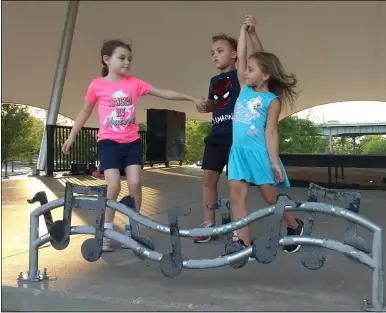  ?? RICHARD PAYERCHIN — THE MORNING JOURNAL ?? From right, beginning Irish dancers Ava Cox, 6, Daniel Smith, 8, and Maura Smith, 5, all of Lorain, work on their steps under the stage canopy Sept. 14at Black River Landing in Lorain.