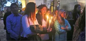  ?? AP PHOTO BY MIKE BALSAMO ?? People attend a candleligh­t vigil in Santa Barbara Sunday to pay tribute to the people who were killed when mudslides ravaged Southern California.