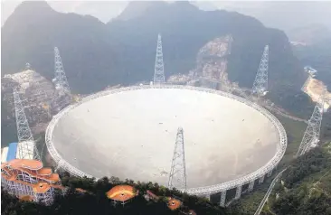  ?? CHINATOPIX VIA AP ?? An aerial view shows the 500-meter Aperture Spherical Telescope in southwest China's Guizhou province. The world's largest radio telescope began searching for signals from stars and galaxies and, perhaps, extraterre­strial life.