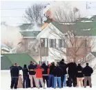  ?? DOUG RAFLIK/USA TODAY NETWORK-WISCONSIN ?? Federal and local law enforcemen­t personnel watch as explosives found in an apartment building in Beaver Dam are detonated Wednesday. The explosives were found after a previous explosion killed the apartment’s tenant Monday.