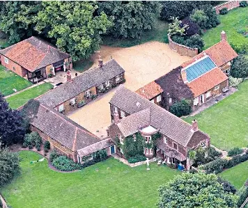  ??  ?? Home comforts: Wood Farm in Norfolk, where the Queen has often been spotted driving one of her Land Rovers, below