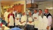  ?? PHOTO BY LEFTERIS PLEVRAKIS ?? Volunteer cooks from the Berks County chapter of the AHEPA take a break after preparing a meal for hundreds of guests.