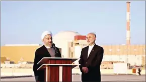  ?? IRANIAN PRESIDENCY/AFP ?? Iran’s President Hassan Rouhani (left) and Atomic Energy Organisati­on chief Ali Akbar Salehi address journalist­s at the Bushehr nuclear power plant.