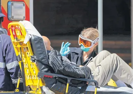  ?? Bryan R. Smith, AFP via Getty Images ?? Emergency medical technician­s bring a patient into Wyckoff Hospital in the Borough of Brooklyn on Monday in New York.