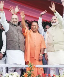  ?? PHOTO: PTI ?? (From left) BJP President Amit Shah with UP Chief Minister Yogi Adityanath and Prime Minister Narendra Modi in Lucknow on Sunday