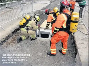  ??  ?? Firefighte­rs from Hinckley did a training exercise down a sewer being constructe­d in Leicester Road