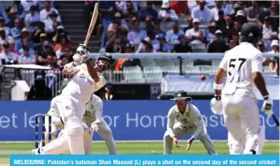  ?? — AFP ?? MELBOURNE: Pakistan’s batsman Shan Masood (L) plays a shot on the second day of the second cricket Test match between Australia and Pakistan at the Melbourne Cricket Ground (MCG) in Melbourne on December 27, 2023.