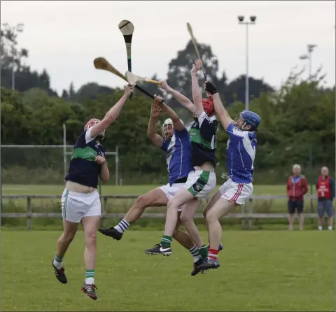  ??  ?? Bray’s Pádraig Doyle and Liam Benville jump with Éire Óg’s Stephen Kelly and Ciaran Goff. Photo: Barbara Flynns