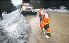  ?? Gary Coronado Los Angeles Times ?? CALTRANS WORKER Wendy Payne removes debris after heavy rains, ice dams and mud led to f looding along Highway 89 south of Truckee, Calif., this week.