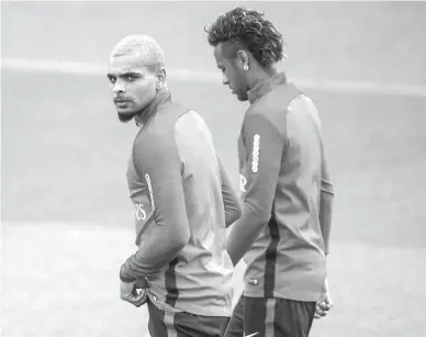  ?? Associated Press ?? n Paris Saint-Germain's Layvin Kurzawa, left, and Neymar arrive during a training session Friday at the Camp des Loges training center in Saint Germain en Laye, west of Paris.