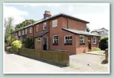  ??  ?? The Station Cottages at Cliddesden, with the station house in the background (right). The principal intermedia­te stations at Bentworth &amp; Lasham, Herriad and Cliddesden had similar arrangemen­ts of station house and cottages - all are extant.