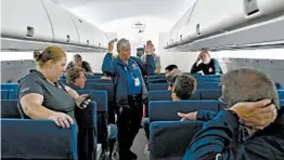  ?? SUE OGROCKI/AP ?? The FAA’s David Ruppel gives instructio­ns to members of the media before a simulation of a plane’s cabin filling with smoke Thursday at a research facility in Oklahoma City.