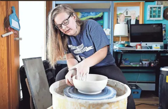  ?? KYLE ROBERTSON/COLUMBUS DISPATCH PHOTOS ?? Quinn Hanna, a 17-year-old ceramicist who started her own business, makes a bowl at her home in Clinton Township on Nov. 7.