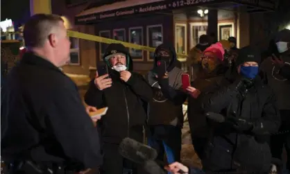  ?? Photograph: Jeff Wheeler/AP ?? Minneapoli­s Police spokesman John Elder briefs community members and others about the shooting