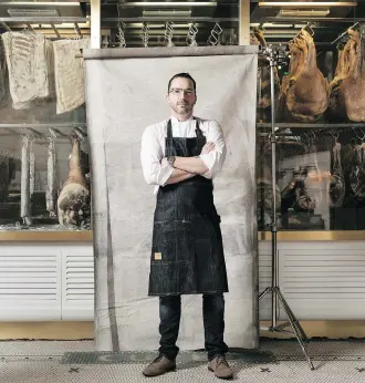  ?? JOSH HUSKIN ?? Chef Steve McHugh in front of his antique meat cooler at the entry to Cured, his eatery in San Antonio’s trendy pearl district.