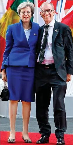  ??  ?? Defiant: Mrs May and husband Philip in Hamburg yesterday