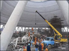  ?? AP ?? Rescue workers look for survivors after a work platform collapsed at the Fengcheng power plant in eastern China’s Jiangxi province and killed at least 40 yesterday.