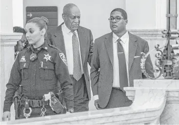  ?? Michael Bryant / AFP / Getty Images ?? Bill Cosby is escorted out of court Tuesday during the second day of jury selection in the comedian’s sexual assault retrial. Cosby maintains the sexual contact with his accuser, Andrea Constand, was consensual.