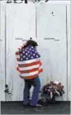  ?? Gene J. Puskar ?? The Associated Press Chrissy Bortz of Latrobe, Pa., pays her respects at the Wall of Names at the Flight 93 National Memorial in Shanksvill­e, Pa.