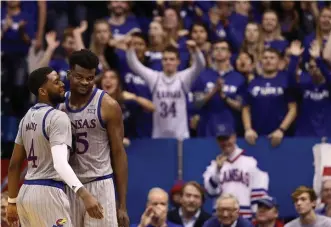  ?? GETTY IMAGES ?? STILL ON TOP: Udoka Azubuike smiles with Kansas teammate Isaiah Moss after being fouled against Oklahoma State on Feb. 24.