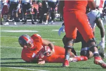  ?? WILL WEBBER/THE NEW MEXICAN ?? UNM sophomore quarterbac­k Tevaka Tuioti is sacked during the second quarter of Saturday’s 45-31 loss to Hawaii in Albuquerqu­e. He led a rally in the second half.