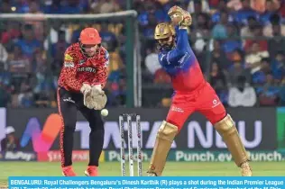  ?? – AFP ?? BENGALURU: Royal Challenger­s Bengaluru’s Dinesh Karthik (R) plays a shot during the Indian Premier League (IPL) Twenty20 cricket match between Royal Challenger­s Bengaluru and Sunrisers Hyderabad at the M Chinnaswam­y Stadium in Bengaluru.