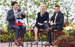  ?? AARON LYNETT/THE CANADIAN PRESS ?? Justin Trudeau holds up a pair of socks he received as a gift from Kelly Ripa and Ryan Seacrest during his appearance on their show Monday in Niagara Falls.