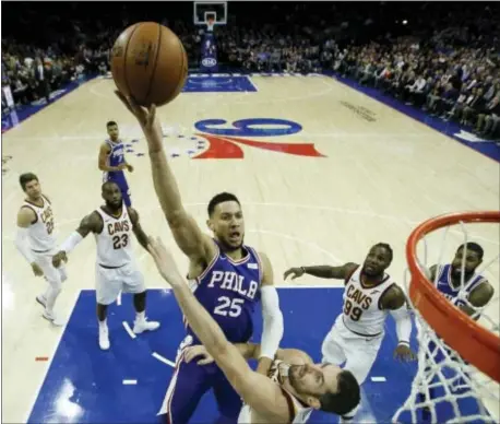  ?? THE ASSOCIATED PRESS ?? 76ers’ Ben Simmons (25) goes up for a shot against Cleveland Cavaliers’ Kevin Love during the first half.