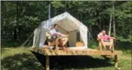  ?? MARY ESCH — THE ASSOCIATED PRESS ?? In this Friday, June 29, 2018, photo, Michael D’Agostino, left, sits with David Derstine at his Tentrr campsite on a 200-acre organic farm in Berlin, N.Y.