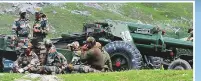  ?? Reuters ?? Indian army soldiers rest next to artillery guns at a makeshift transit camp before heading to Ladakh.