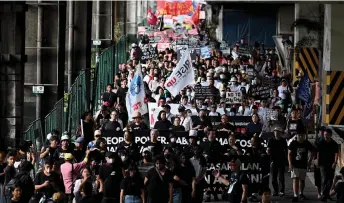  ?? — AFP photo ?? Hundreds of protesters march during a demonstrat­ion commemorat­ing the 38th anniversar­y of the ‘People Power’ revolution, which ousted Philippine President Ferdinand Marcos Jr’s dictator father and sent the family into exile, on Epifanio de los Santos Avenue, or EDSA, in Quezon City.