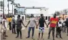  ?? PHOTO: REUTERS ?? United . . . Demonstrat­ors hold hands as they gather near the Lagos State House yesterday in a protest against alleged police brutality in Nigeria.