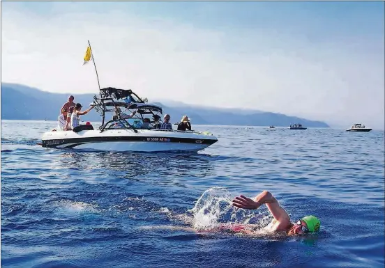  ?? PAM LEBLANC/AMERICAN-STATESMAN PHOTOS ?? Bret Cunningham of Austin, a member of Keep Tahoe Weird, swims across Lake Tahoe during the Trans Tahoe Relay on July 21.