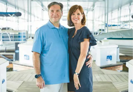  ?? KELLY BLACKMON/THE NEW YORK TIMES ?? Amy and Peter Lyle at the dock where they keep their boat in Georgia. The couple have canceled three trips since the start of the pandemic.