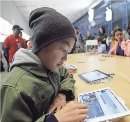  ?? MARCIO JOSE SANCHEZ/AP ?? Tyson Navarro, 10, of Fremont, Calif., learns to build code using an iPad in 2013. Code.org said a record number of female and underrepre­sented minorities took AP computer science classes in 2018.