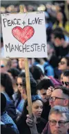  ?? PHOTO: REUTERS ?? In loving memory . . . People attend a vigil for the victims of the Manchester Arena attack.