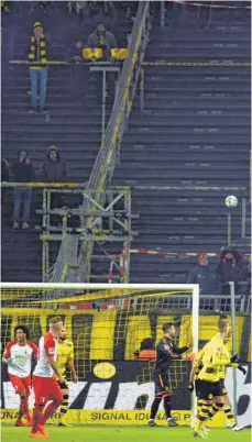  ?? FOTO IMAGO ?? Der Kick zwischen Borussia Dortmund (in Gelb) und dem FC Augsburg war so lala, hätte aber durchaus mehr Zuschauer verdient gehabt. Große Teile der Dortmunder Südtribüne blieben aber wegen des Protests vieler Fans gegen die neuen Montagsspi­ele leer.
