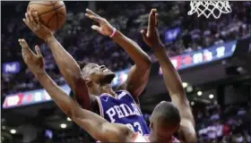  ?? FRANK GUNN — THE ASSOCIATED PRESS ?? Philadelph­ia 76ers guard Jimmy Butler (23) shoots as Toronto Raptors centre Serge Ibaka (9) defends during the first half of Game 5 of an NBA basketball second-round playoff series.