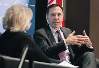  ?? GAVIN YOUNG ?? Federal Finance Minister Bill Morneau takes part in a question-and-answer session with University of Calgary president Elizabeth Cannon during a Calgary Chamber of Commerce luncheon on Tuesday.