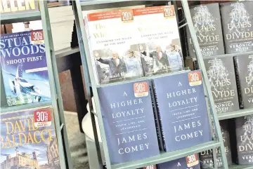  ?? — AFP photo ?? Copies of ‘A Higher Loyalty: Truth, Lies, and Leadership,’ a new book by former FBI Director James Comey, sit on a shelf for sale at a Barnes & Noble bookstore in New York City.