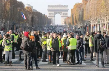  ?? MICHEL EULER/AP ?? Protesters block the Champs-Elysees on Saturday in Paris to protest fuel taxes.