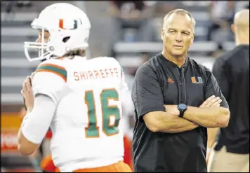  ?? STEVE HELBER / ASSOCIATED PRESS ?? Miami coach Mark Richt watches his players warm up before the Hurricanes were routed by Virginia Tech 37-16 on Thursday.