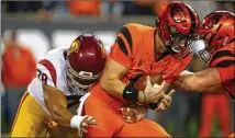  ?? TIMOTHY J. GONZALEZ/AP 2018 ?? USC’S Jay Tufele (left, sacking Oregon State QB Jake Luton) opted out of the 2020 season due to coronaviru­s concerns. He’s a likely second- or third-round pick.