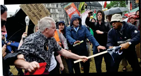  ??  ?? Flashpoint: Tug of war over protest sign as row escalates