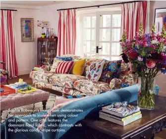  ??  ?? Sophie Robinson’s living room demonstrat­es her approach to scale when using colour and pattern. One sofa features the dominant floral fabric, which contrasts with the glorious candy-stripe curtains.